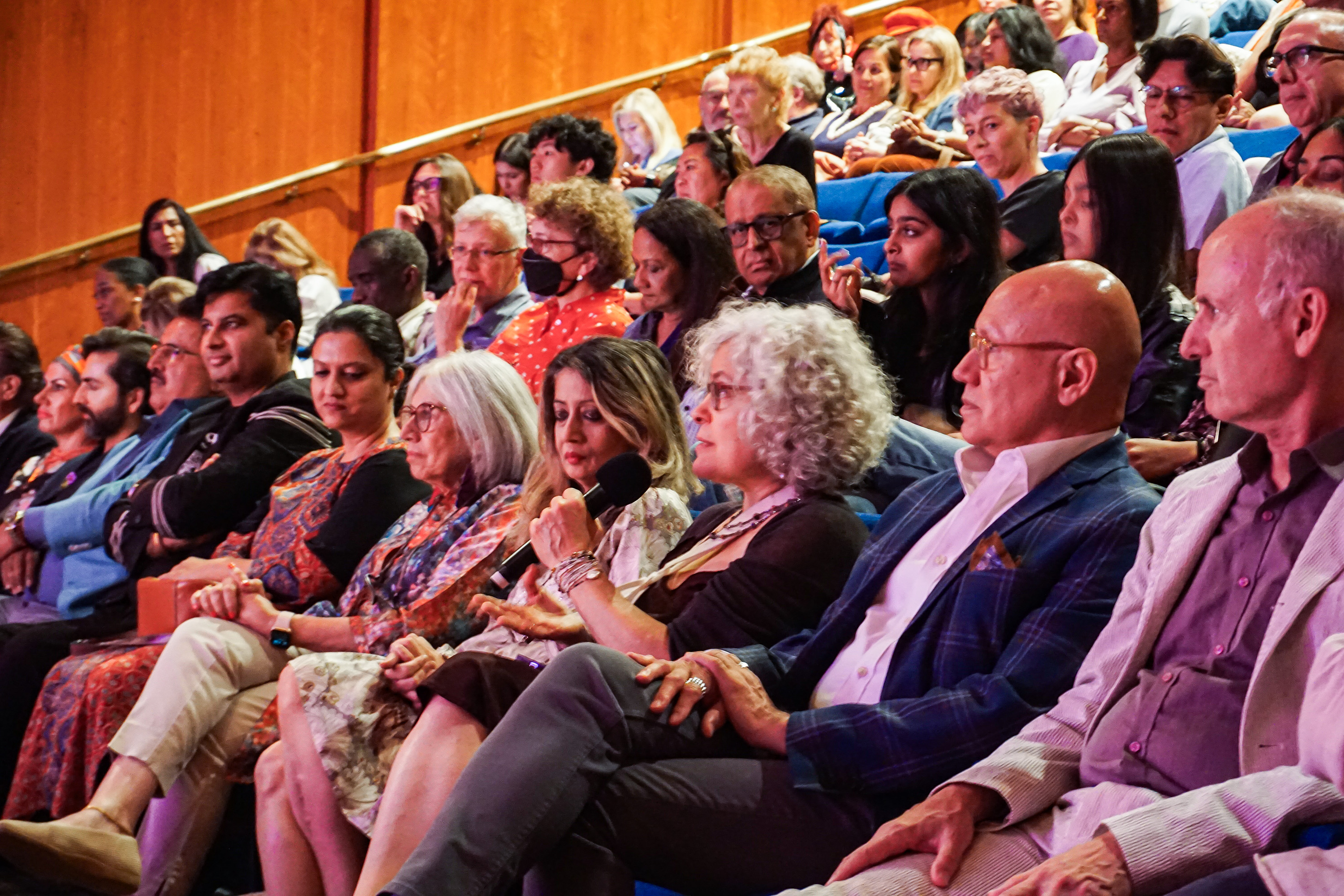 audience member at Asia Society NY speaking into the microphone in a crowd of seated people