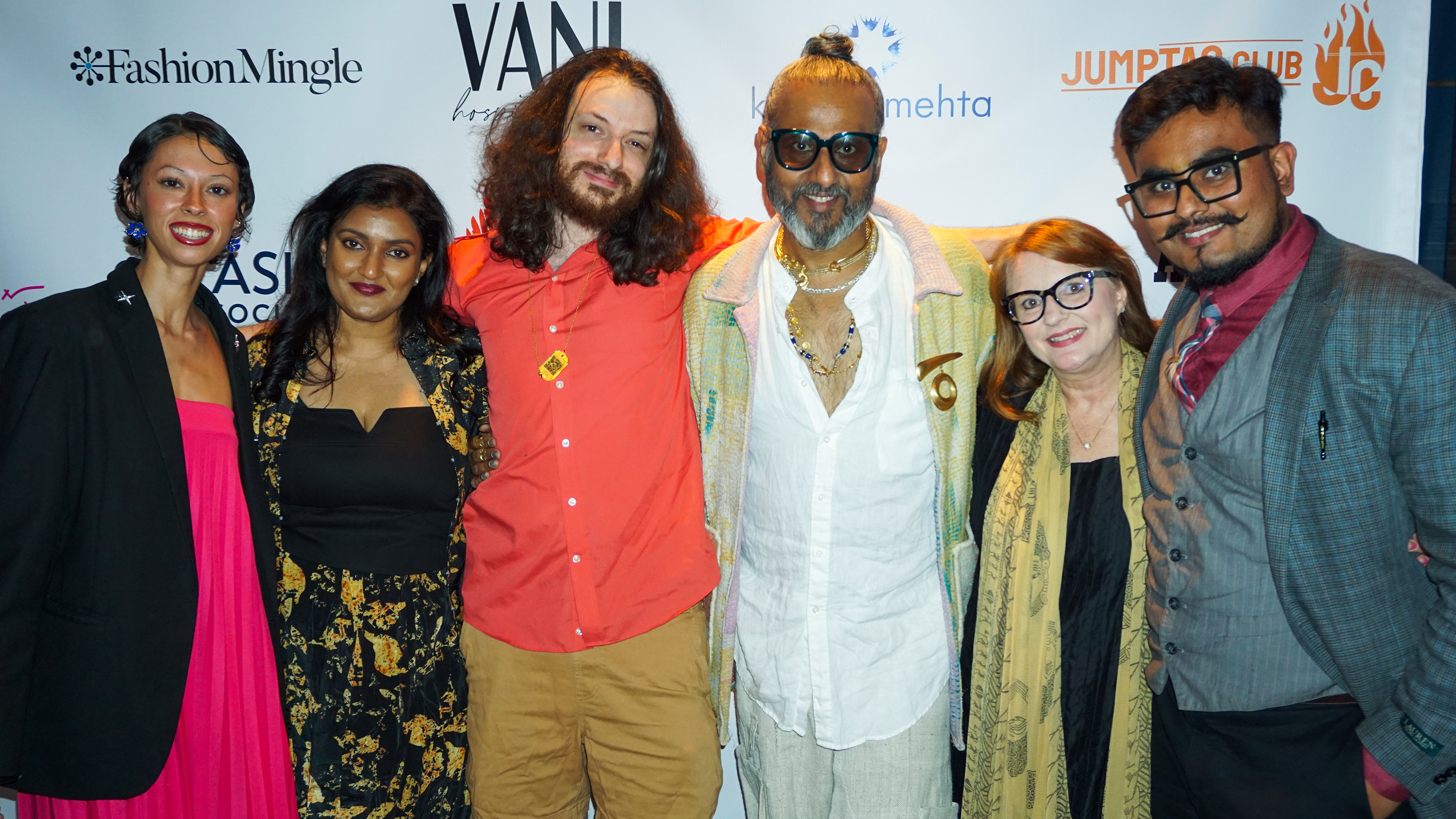 Rito, Ajay Shrivastav, Ajay's son, Melissa Shea, Victoria Roberts, Sneha Andani posing in front of a step and repeat banner