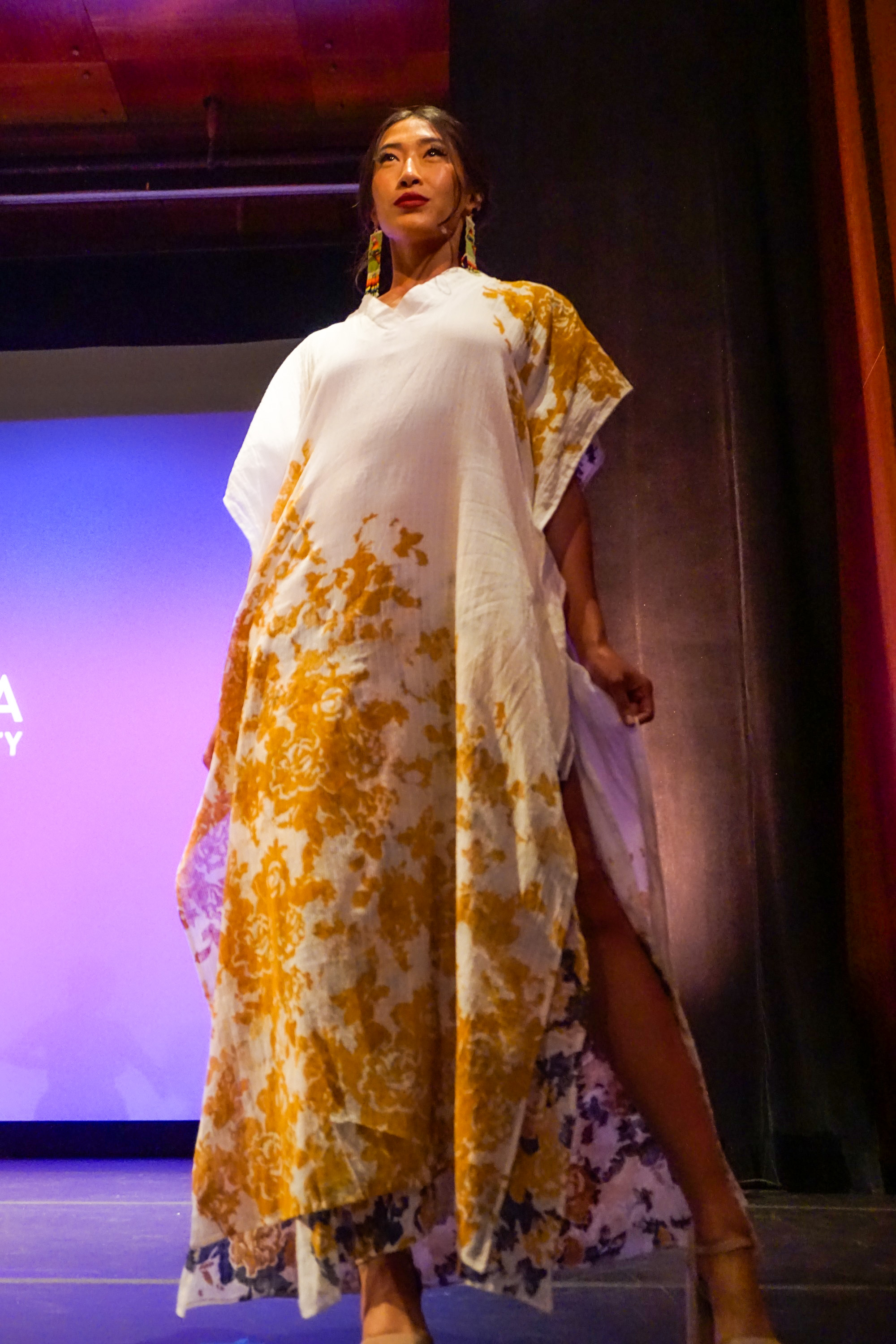 Female Asian model wearing Indian-style dress on a runway