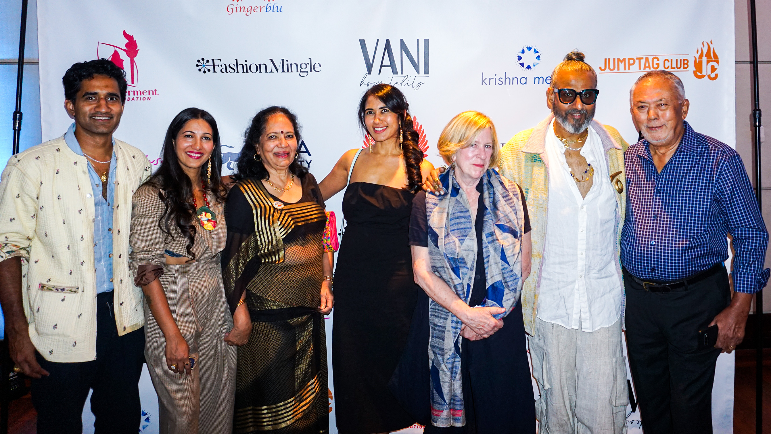 crowd gathered in front of step and repeat banner including Ajay Shrivastav, Kiren Srivastav, Poonam Thimmaiah, Rachel Cooper